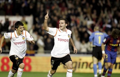 Valencia's duo, David Villa and Juan Mata, celebrating their goal against Barcelona FC.